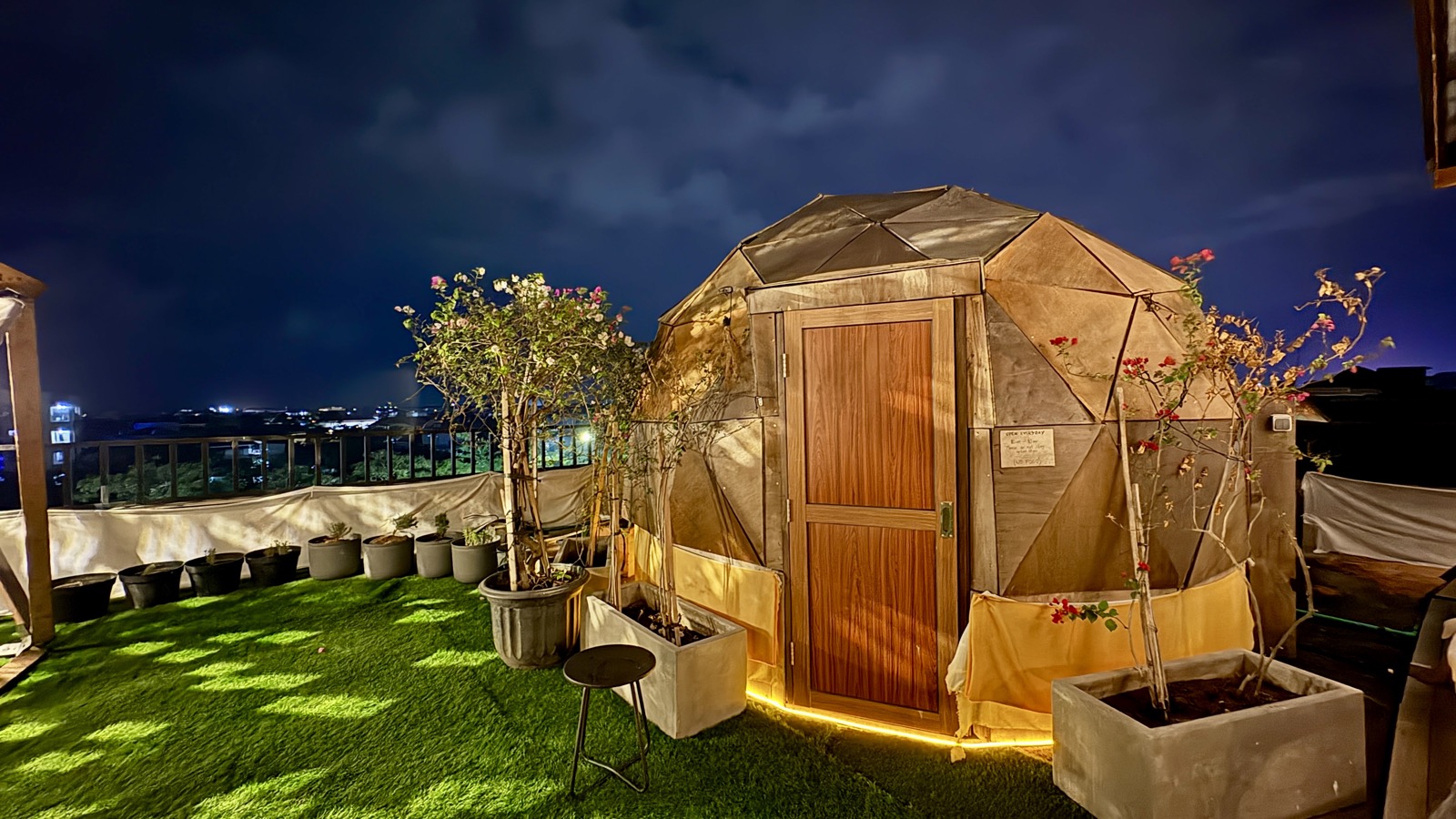 Geodesic dome sauna glowing at night on the Kuta rooftop lawn